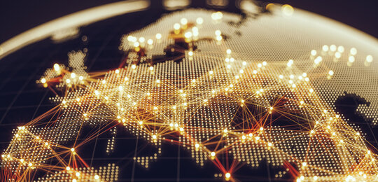 Against a black background is an image of the world showing European countries with cities connected with glowing gold lines to represent the electrical networks