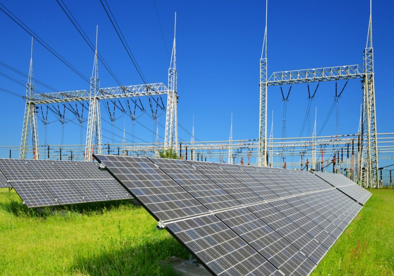 Solar energy panels in the background high voltage power substation