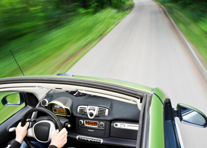 Image showing an electric car driving down an empty road