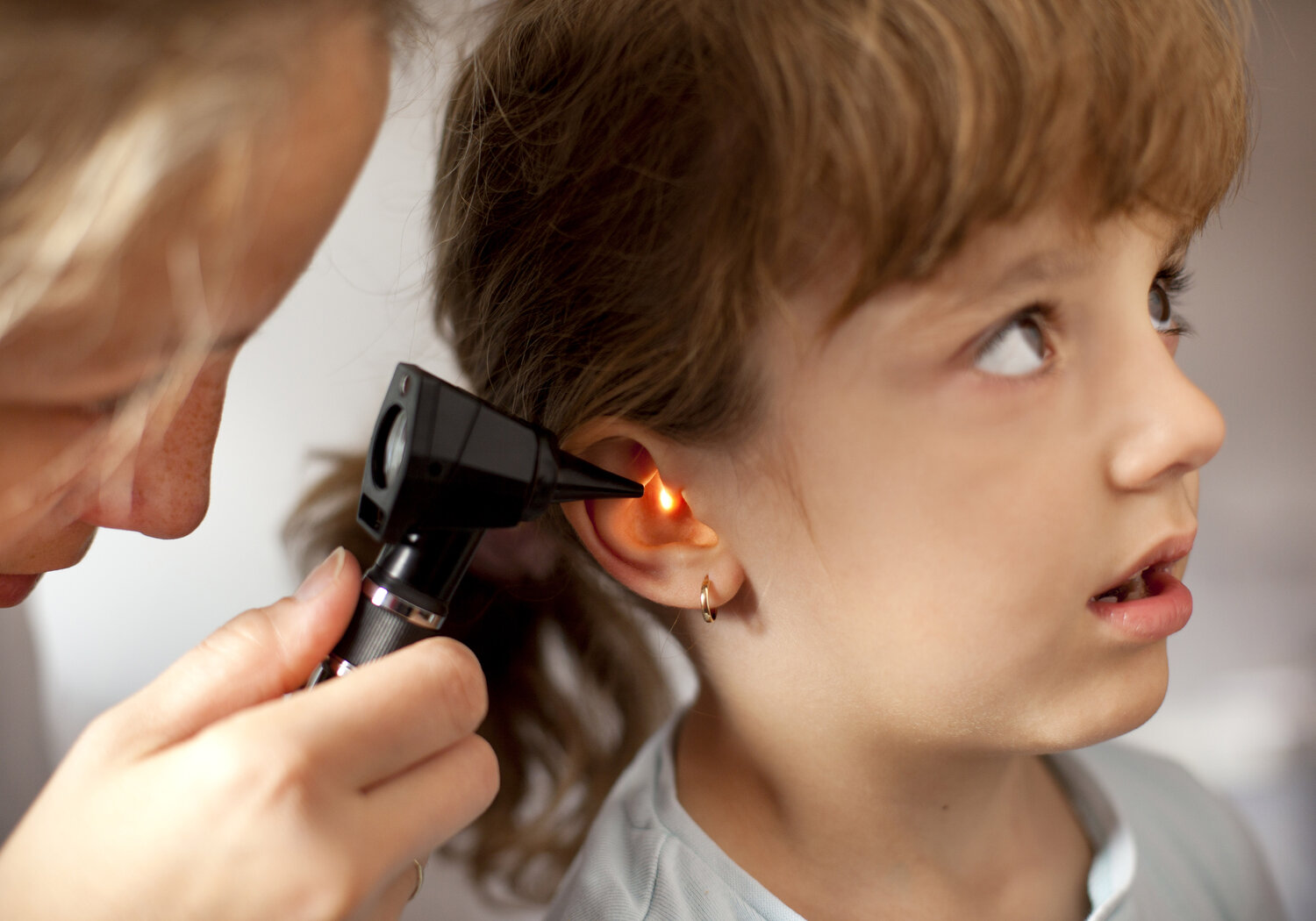 Image showing a Paediatrician performing an ear exam of a young patient