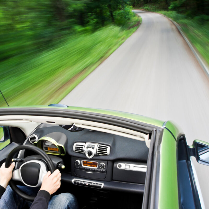 Image showing an electric car driving down an empty road