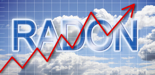 Schematic representation of radon levels increasing in the air. Against a blue sky with white clouds a red arrow climbs upwards over the words RADON in large letters