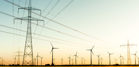 Power poles and wind turbines in autumn sunlight picture