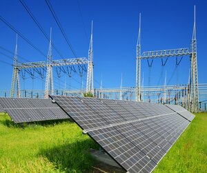Solar energy panels in the background high voltage power substation