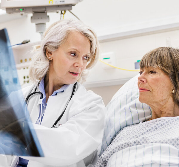 Image of a Doctor with patient examining an x-ray
