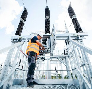 Engineer inspecting equipment in an electric substation