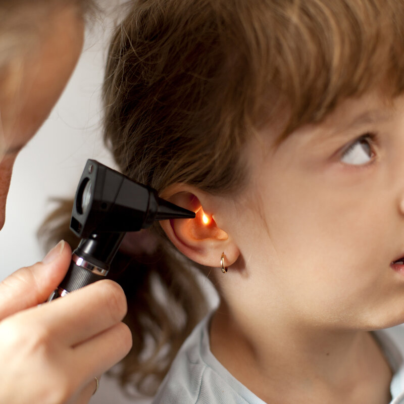 New hearing and noise assessments for public health Image showing a Paediatrician performing an ear exam of a young patient
