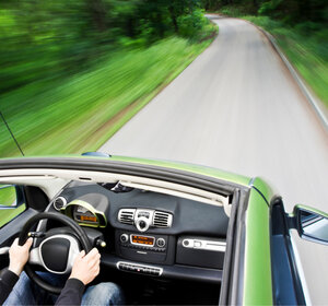 Image showing an electric car driving down an empty road