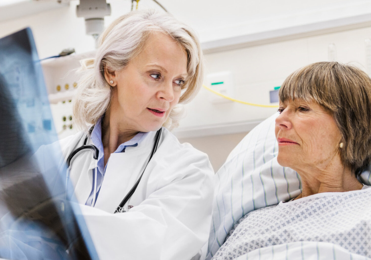 Image of a Doctor with patient examining an x-ray