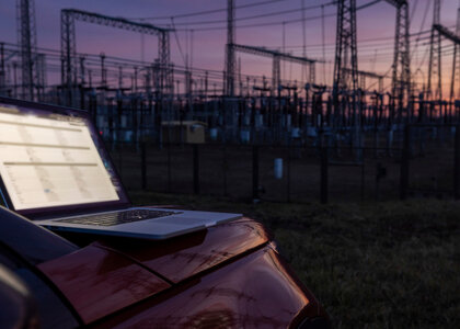 19NRM07 working on laptop near the electric power transmission equipment in picture id1369067638