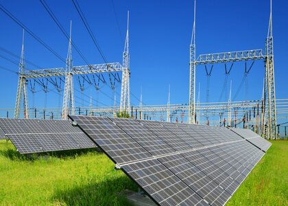 Solar energy panels in the background high voltage power substation Solar energy panels in the background high voltage power substation